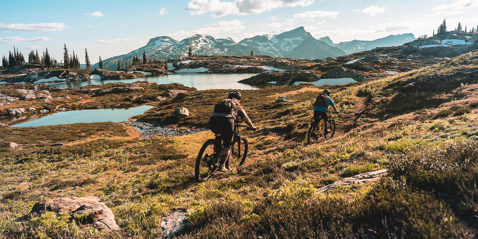 2 mountain bikers riding in alpine terrain at sol mountain lodge